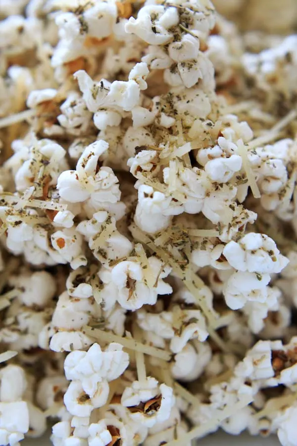 Pizza popcorn is a perfect snack for movie night that's still pretty healthy and full of flavor with dried herbs and parmesan cheese.