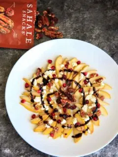 Sweet and savory pear nachos with glazes pecans, chevre cheese, pomegranate seeds and balsamic. A unique snack or dessert!