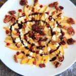 Sweet and savory pear nachos with glazes pecans, chevre cheese, pomegranate seeds and balsamic. A unique snack or dessert!