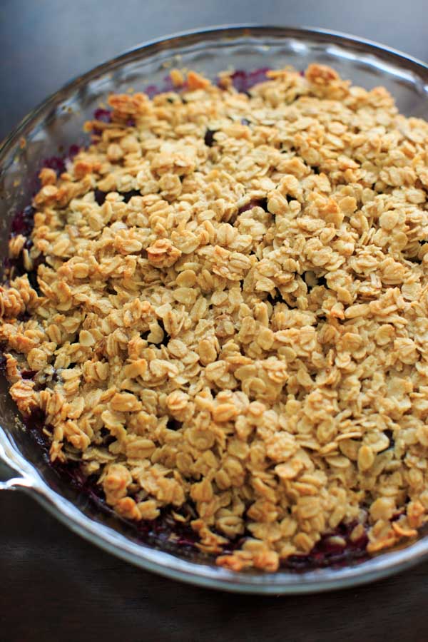 Blueberry crisp crumble with an oat and coconut oil topping. Healthy and fruity dessert that's gluten-free and vegan-friendly.