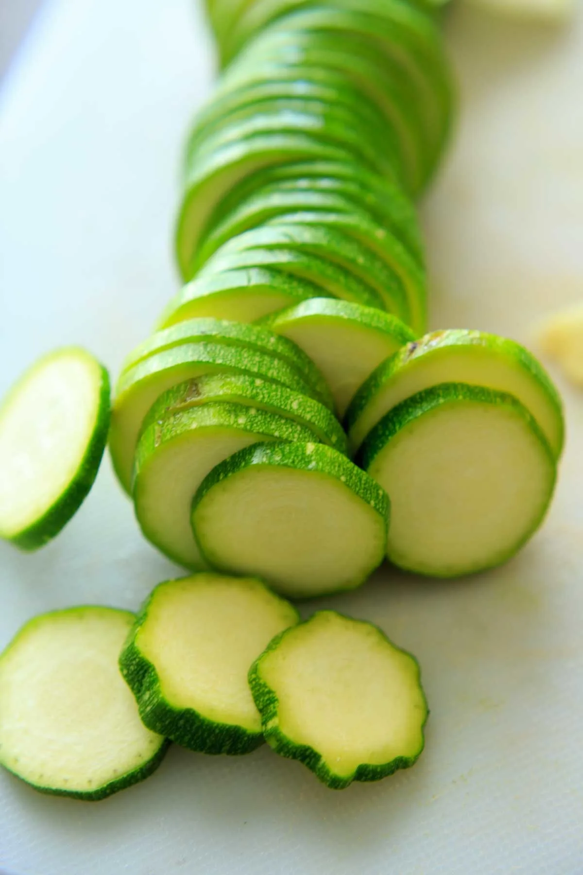 sliced zucchini on white cutting board