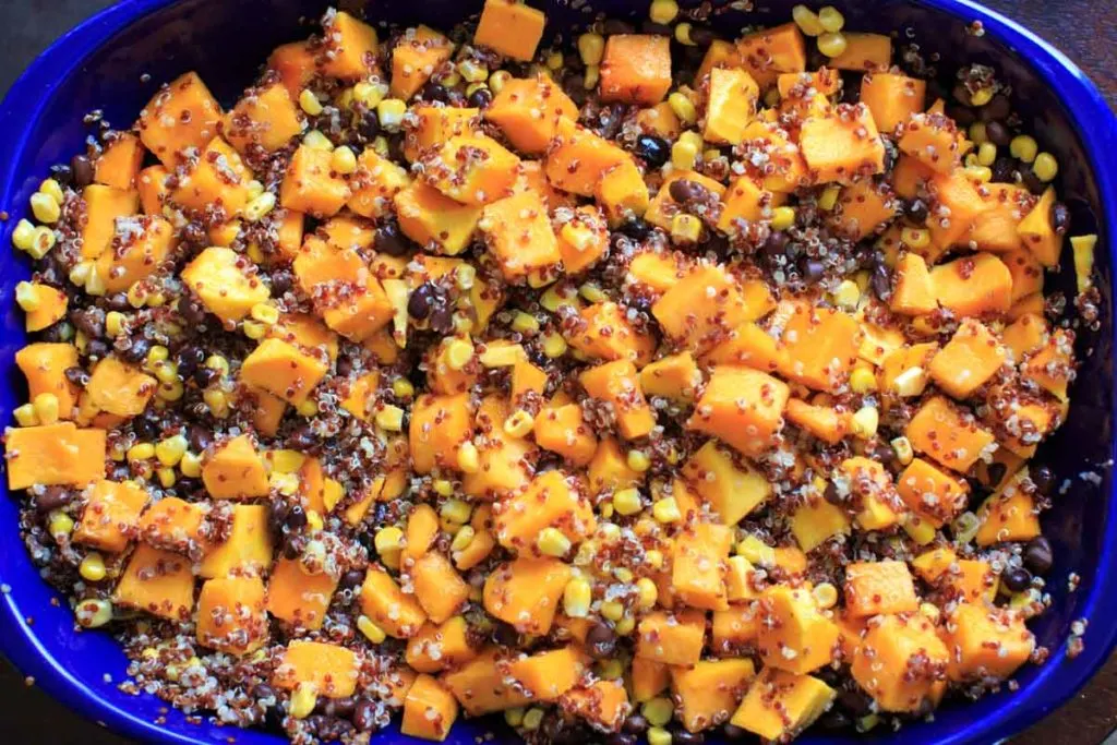 cut up butternut squash and vegetables all together in a casserole pan