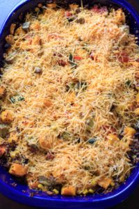 Butternut squash and other vegetables mixed together with quinoa makes a delicious vegetarian, gluten-free, and vegan friendly casserole for the whole family.