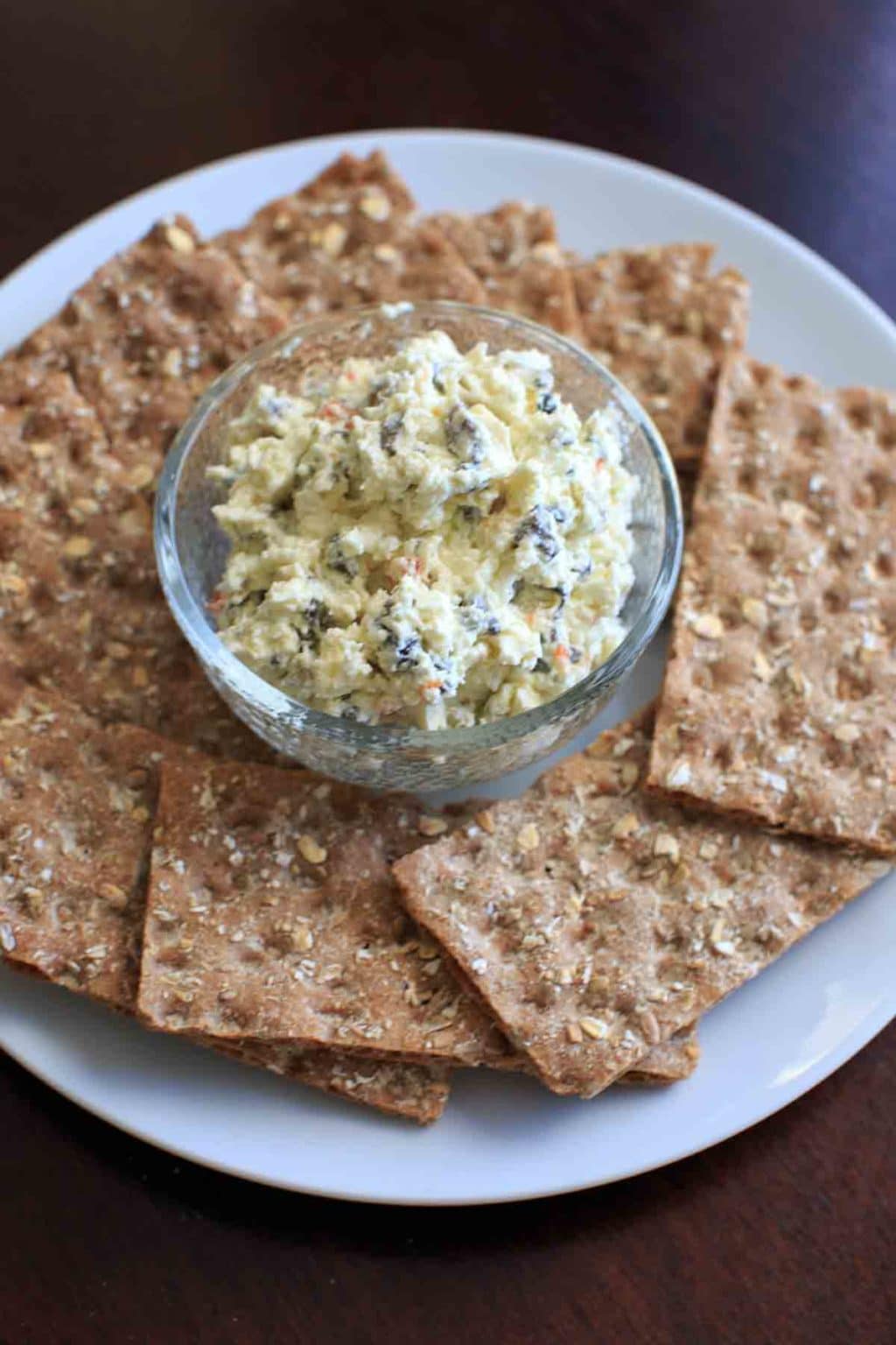 Olive goat cheese dip is a quick and simple appetizer that can be prepared ahead or on the spot. Sure to be a crowd pleaser!