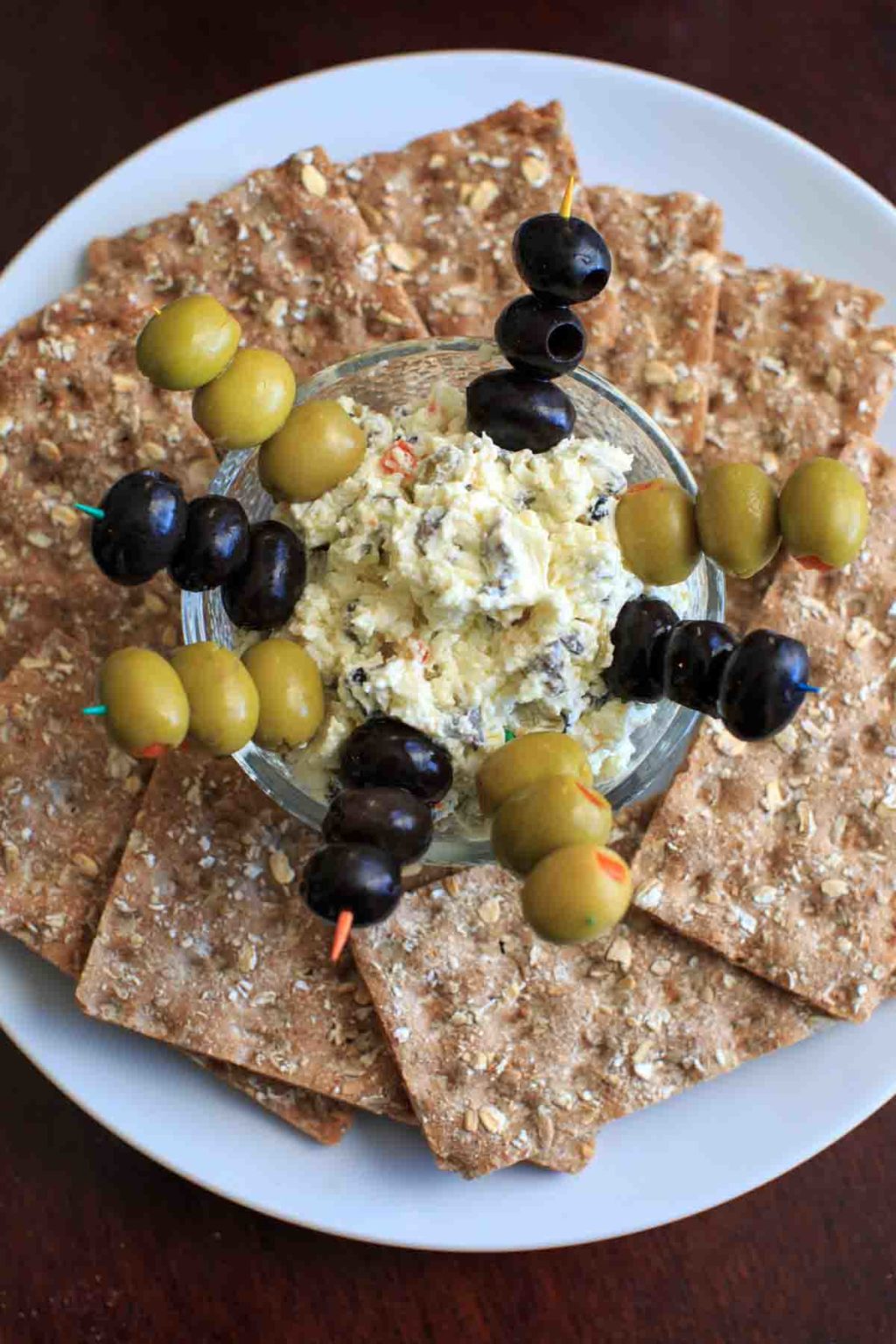 Olive goat cheese dip is a quick and simple appetizer that can be prepared ahead or on the spot. Sure to be a crowd pleaser!