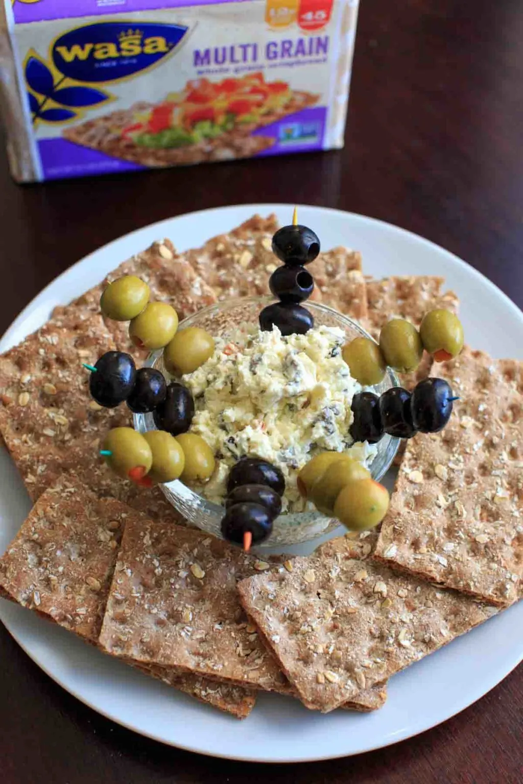 Olive goat cheese dip is a quick and simple appetizer that can be prepared ahead or on the spot. Sure to be a crowd pleaser!