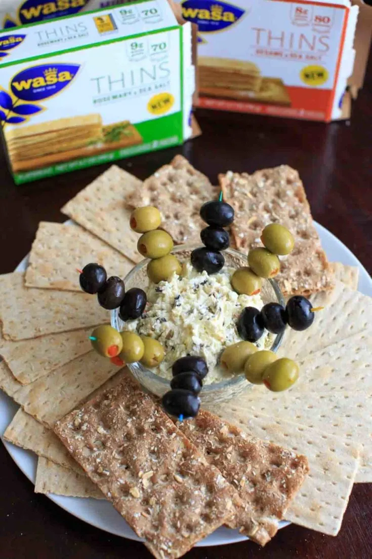 Olive goat cheese dip is a quick and simple appetizer that can be prepared ahead or on the spot. Sure to be a crowd pleaser!