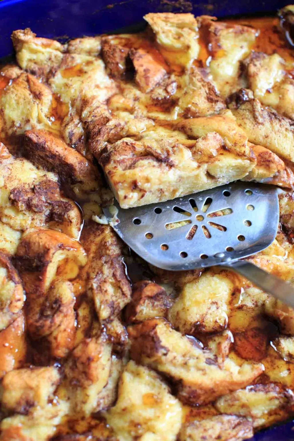 scooping out a portion of french toast casserole with spatula