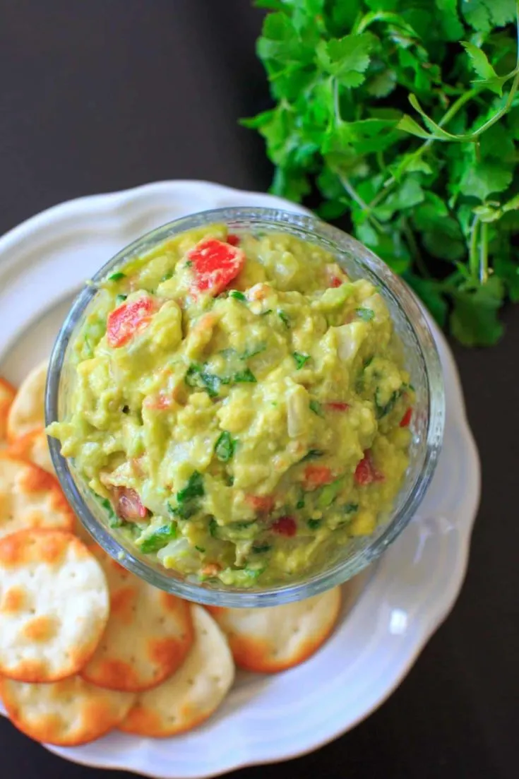 The BEST EVER guacamole recipe that's a little spicy, full of flavor and naturally vegan and gluten-free. Includes tips on how to make it your own if you need to modify.