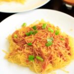 Spaghetti squash noodles and spicy peanut sauce make a delicious, gluten-free and vegan dinner that's easy to prepare!