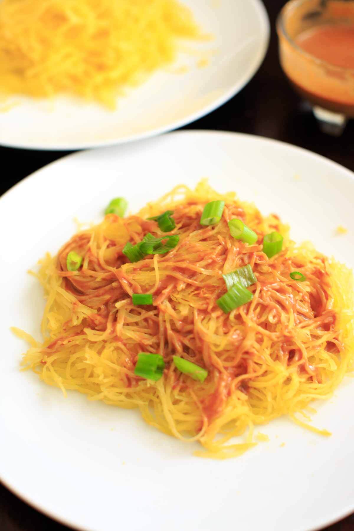 Spaghetti squash noodles and spicy peanut sauce make a delicious, gluten-free and vegan dinner that's easy to prepare!