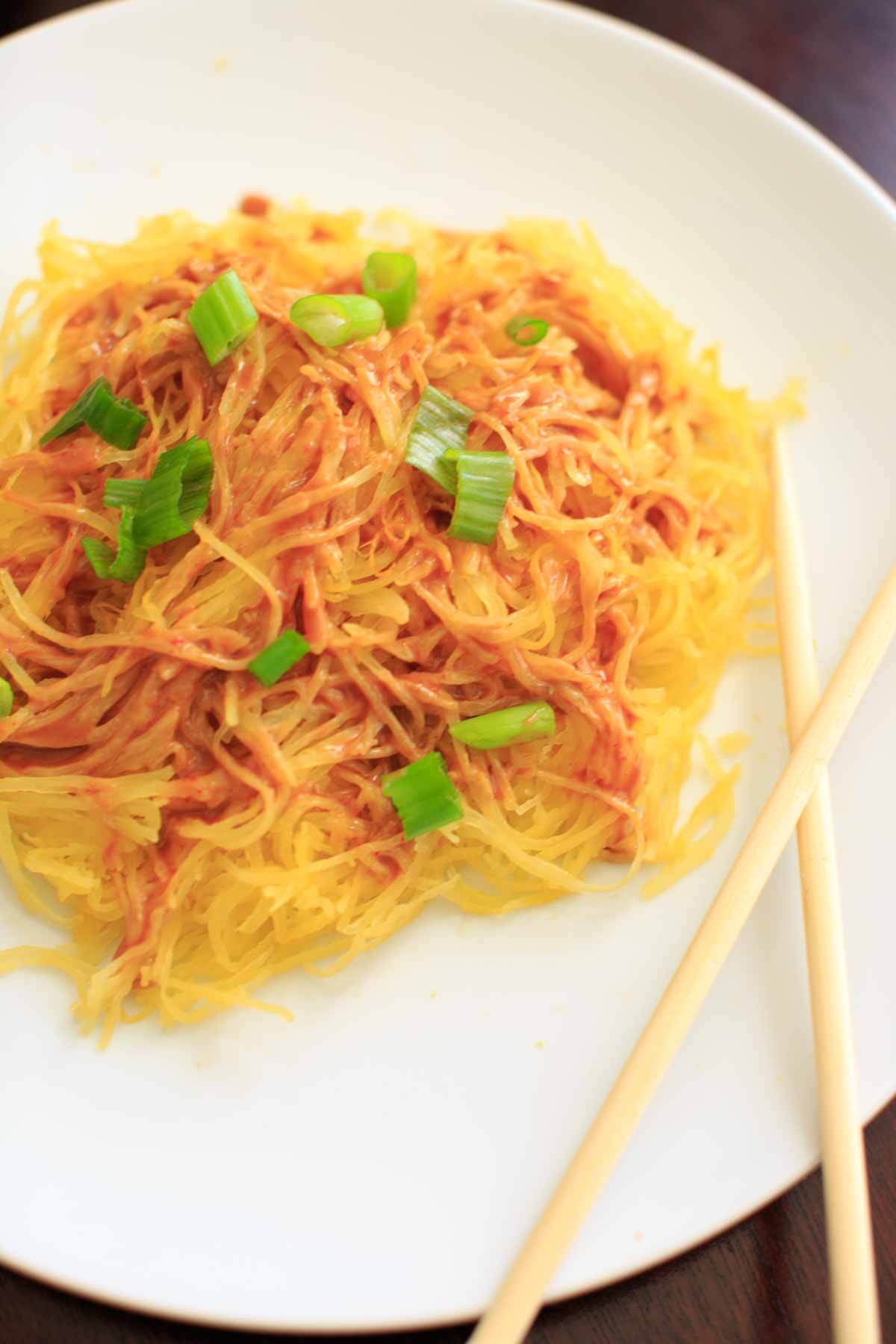 Spaghetti squash noodles and spicy peanut sauce make a delicious, gluten-free and vegan dinner that's easy to prepare!