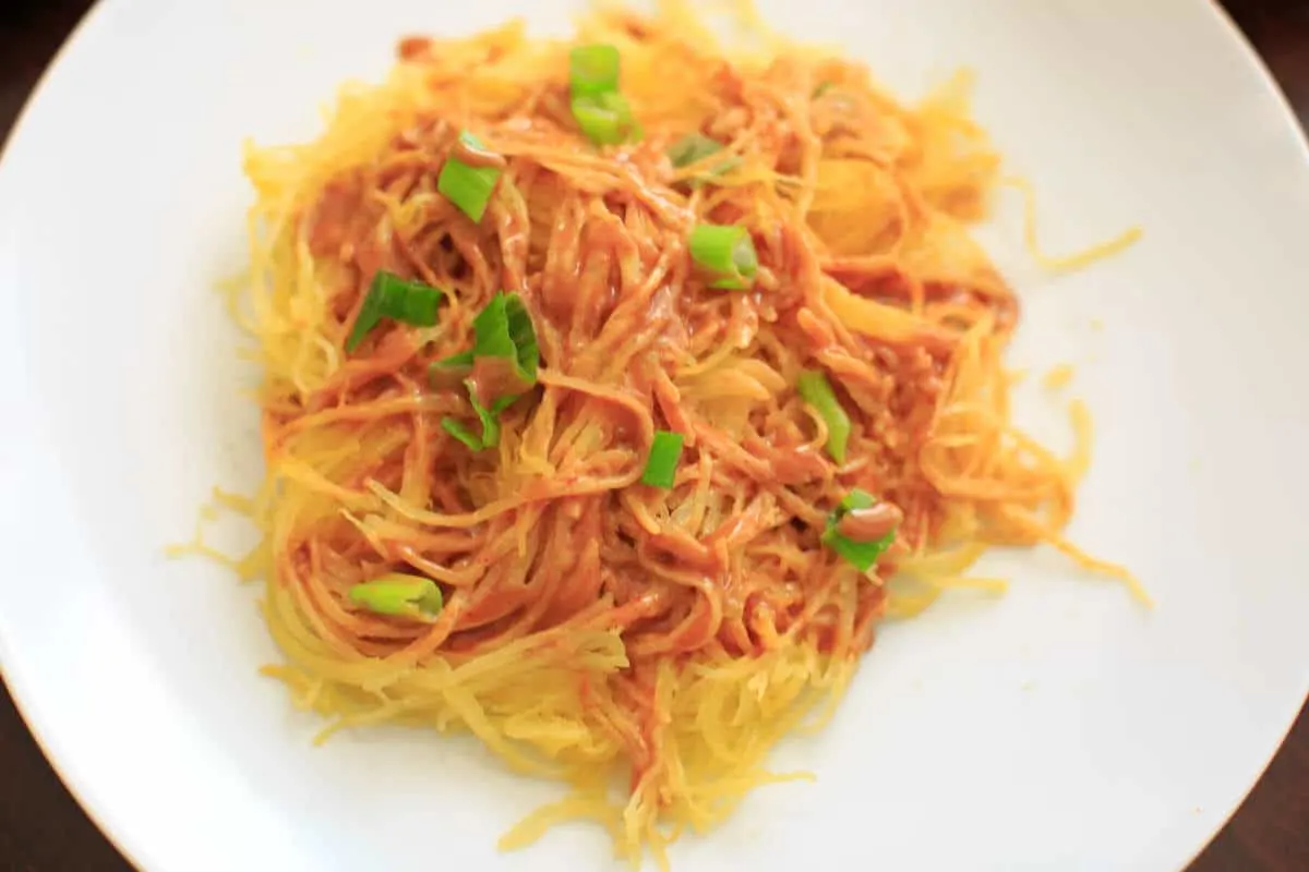 Spaghetti squash noodles and spicy peanut sauce make a delicious, gluten-free and vegan dinner that's easy to prepare!