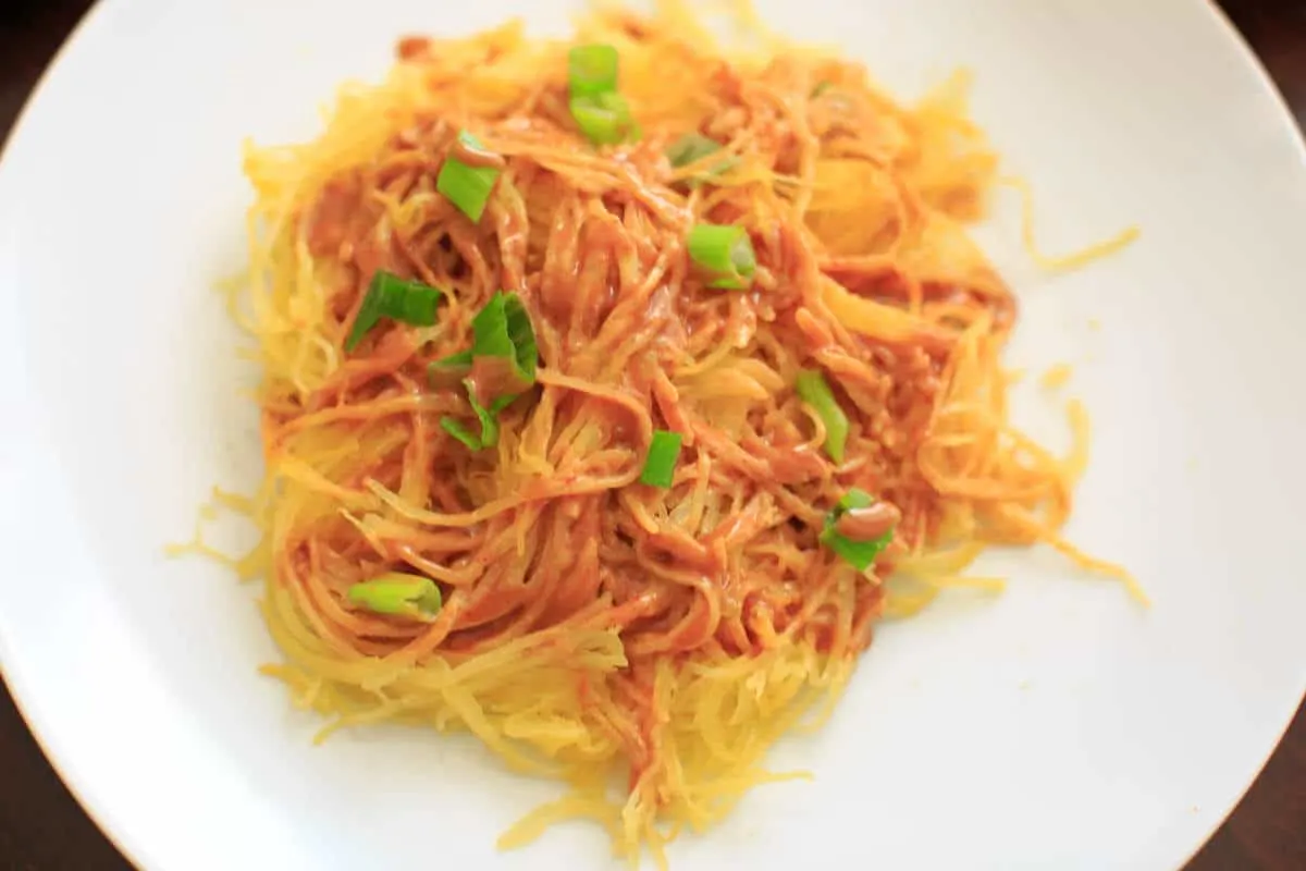 Spaghetti squash noodles and spicy peanut sauce make a delicious, gluten-free and vegan dinner that's easy to prepare!