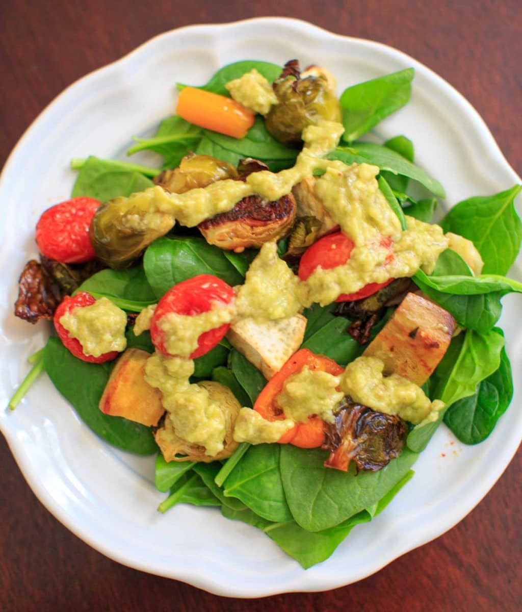Roasted Vegetable Spinach Salad with Avocado Dressing, a.k.a. "Leftover Veggie Salad." Use up your vegetables or roast your favorites for this healthy vegan meal!