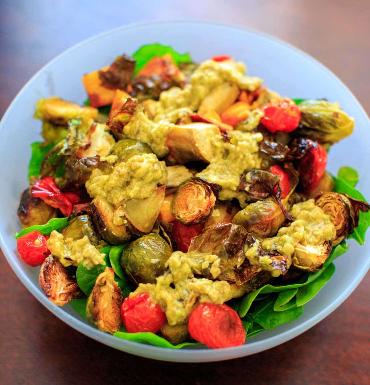 Roasted Vegetable Spinach Salad with Avocado Dressing, a.k.a. "Leftover Veggie Salad." Use up your vegetables or roast your favorites for this healthy vegan meal!