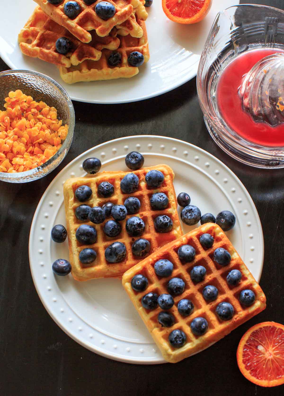 Belgian Waffles made healthy with split red lentils, blood orange juice and blueberries. Breakfast doesn't get any better than this!