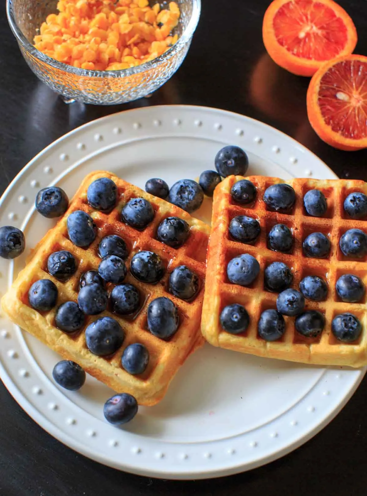 Belgian Waffles made healthy with split red lentils, blood orange juice and blueberries. Breakfast doesn't get any better than this!