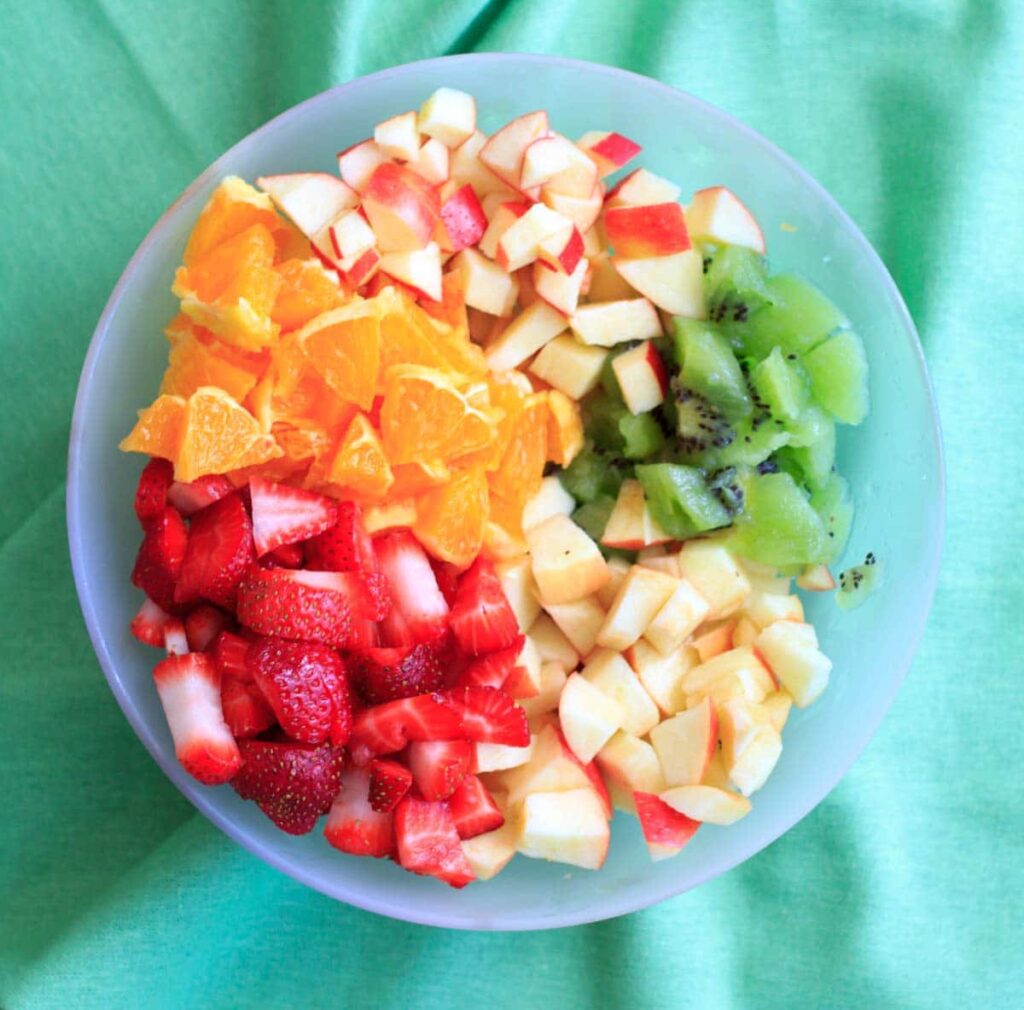 Fruit salsa made from apples, oranges, kiwis and strawberries and tortilla chips baked with cinnamon sugar. Colorful party appetizer or dessert!