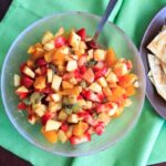 Fruit salsa made from apples, oranges, kiwis and strawberries and tortilla chips baked with cinnamon sugar. Colorful party appetizer or dessert!