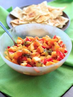 Fruit salsa made from apples, oranges, kiwis and strawberries and tortilla chips baked with cinnamon sugar. Colorful party appetizer or dessert!