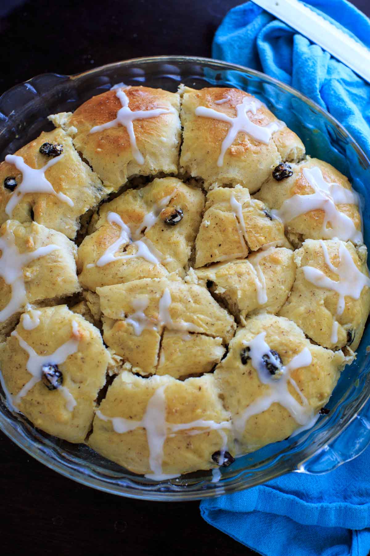 Hot Cross Buns in glass baking dish cut into rolls and iced