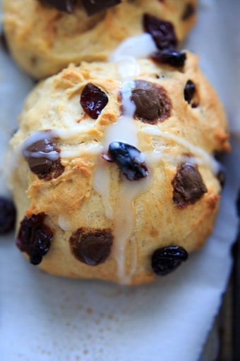 Hot cross buns with dark chocolate and dried cherries with icing cross.
