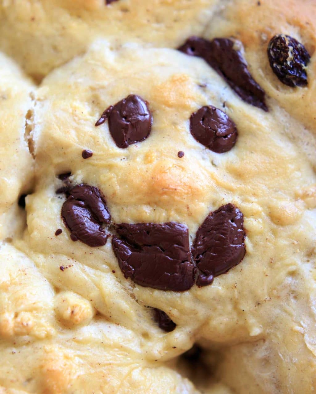 "Not cross" buns made with dark chocolate in shape of smiley face 