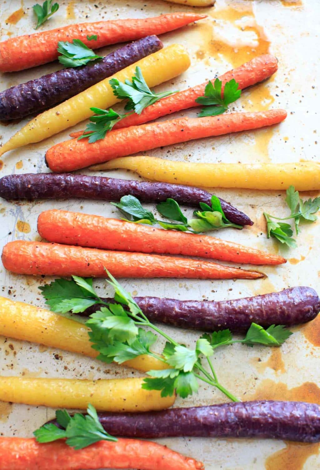 Maple roasted carrots are an easy vegetable side dish that you can throw together for any meal. Vegan and gluten-free, 5 ingredients or less. (Picture is after roasting with fresh parsley.)