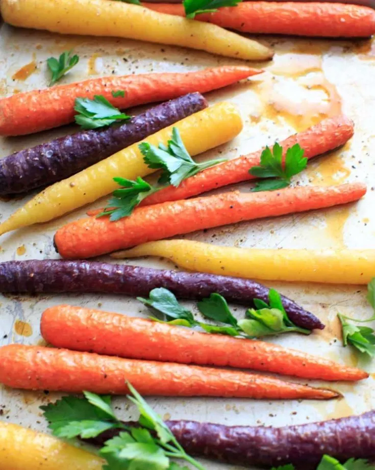 Maple roasted carrots are an easy vegetable side dish that you can throw together for any meal. Vegan and gluten-free, 5 ingredients or less. (Picture is after roasting with fresh parsley, final.)