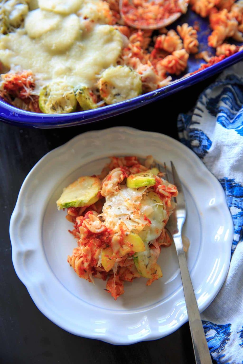 Zucchini Pasta Casserole with thyme. A super easy and healthy casserole that is easily gluten-free. With few ingredients (7 ingredients or less), dinner will be on the table in no time! Picture is plated single serving with full casserole in background.