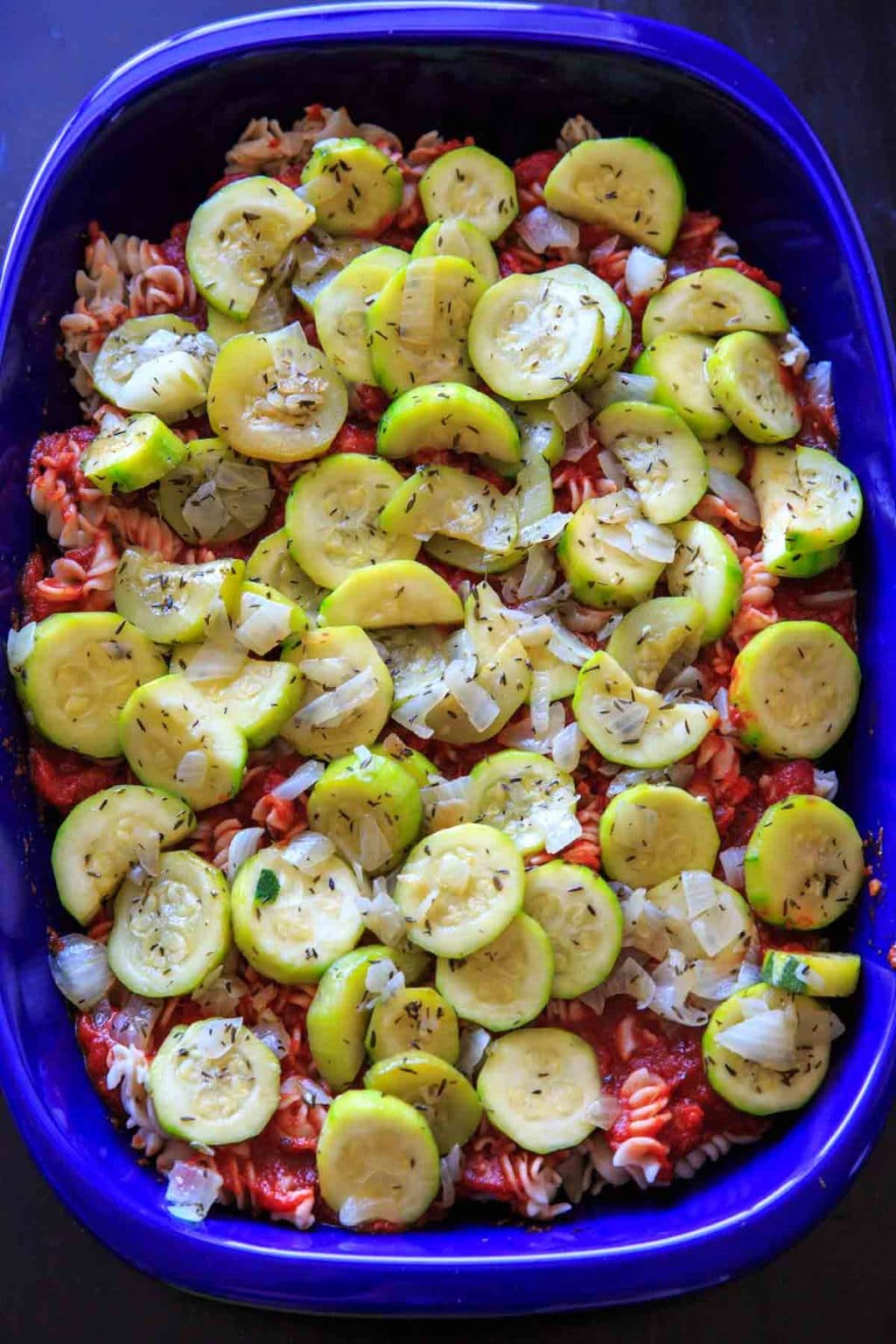 Zucchini Pasta Casserole with thyme. A super easy and healthy casserole that is healthy and easily gluten-free. With few ingredients (7 ingredients or less), dinner will be on the table in no time! Casserole before topping with cheese and baking.