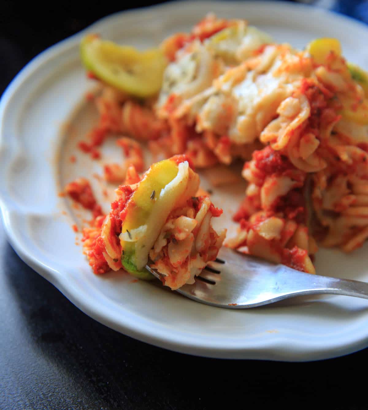 Zucchini Pasta Casserole with thyme. A super easy and healthy casserole that is healthy and easily gluten-free. With few ingredients (7 ingredients or less), dinner will be on the table in no time! Picture is single serving of pasta casserole with a fork bite.