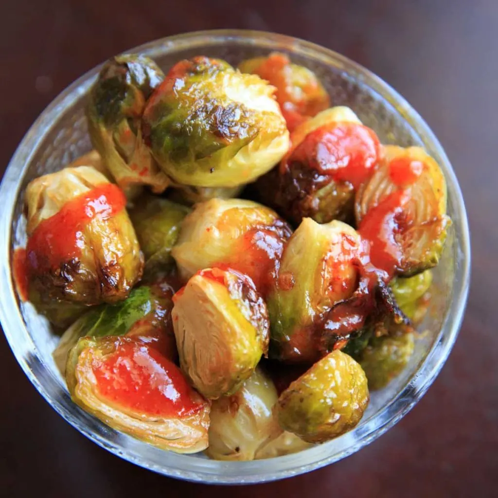 Bang Bang Brussels Sprouts. Easy and spicy side to liven up your veggies. (Pictured is roasted brussels sprouts with extra sriracha sauce.)
