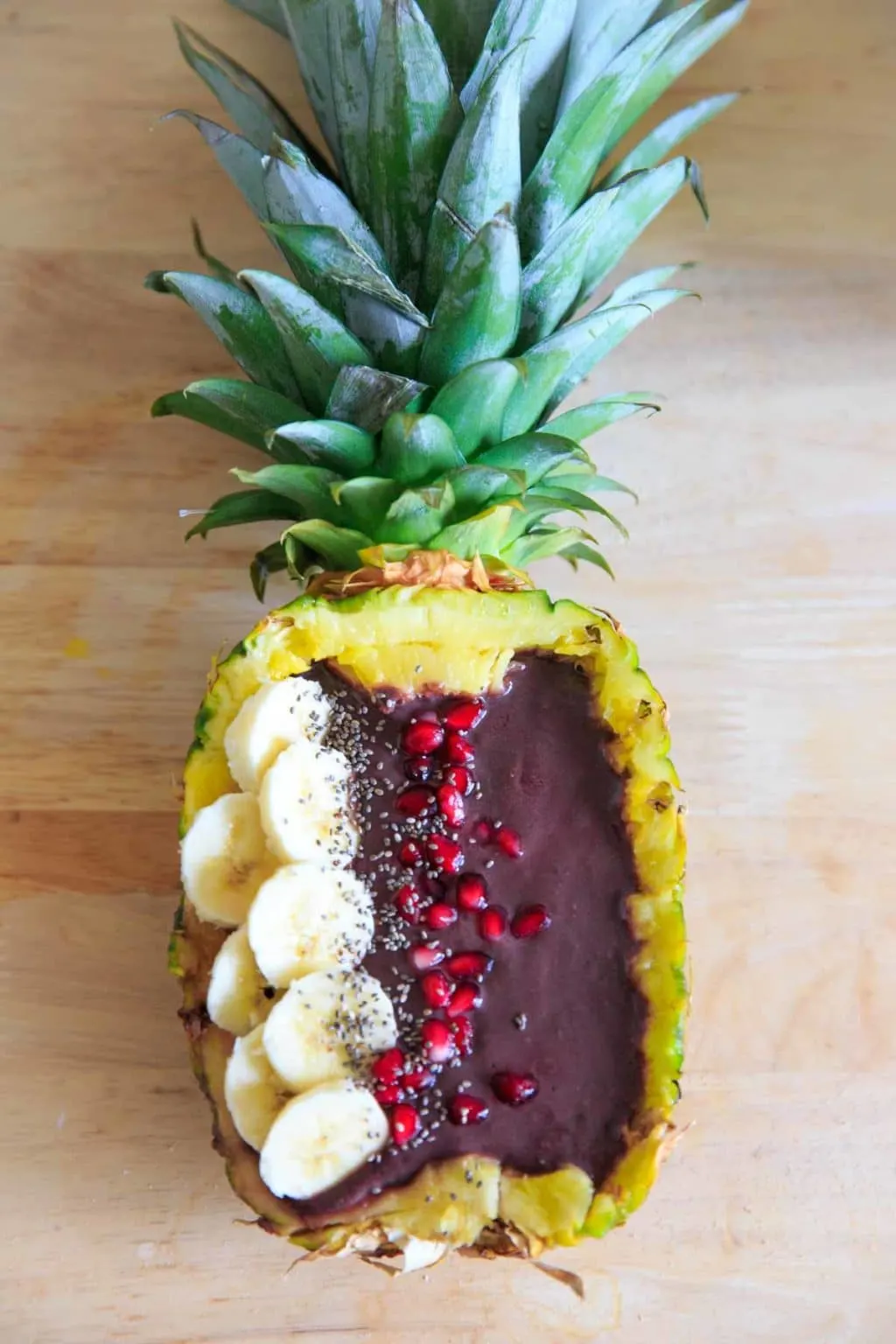 Full Pineapple with banana, pomegranate arils, and chia seeds.