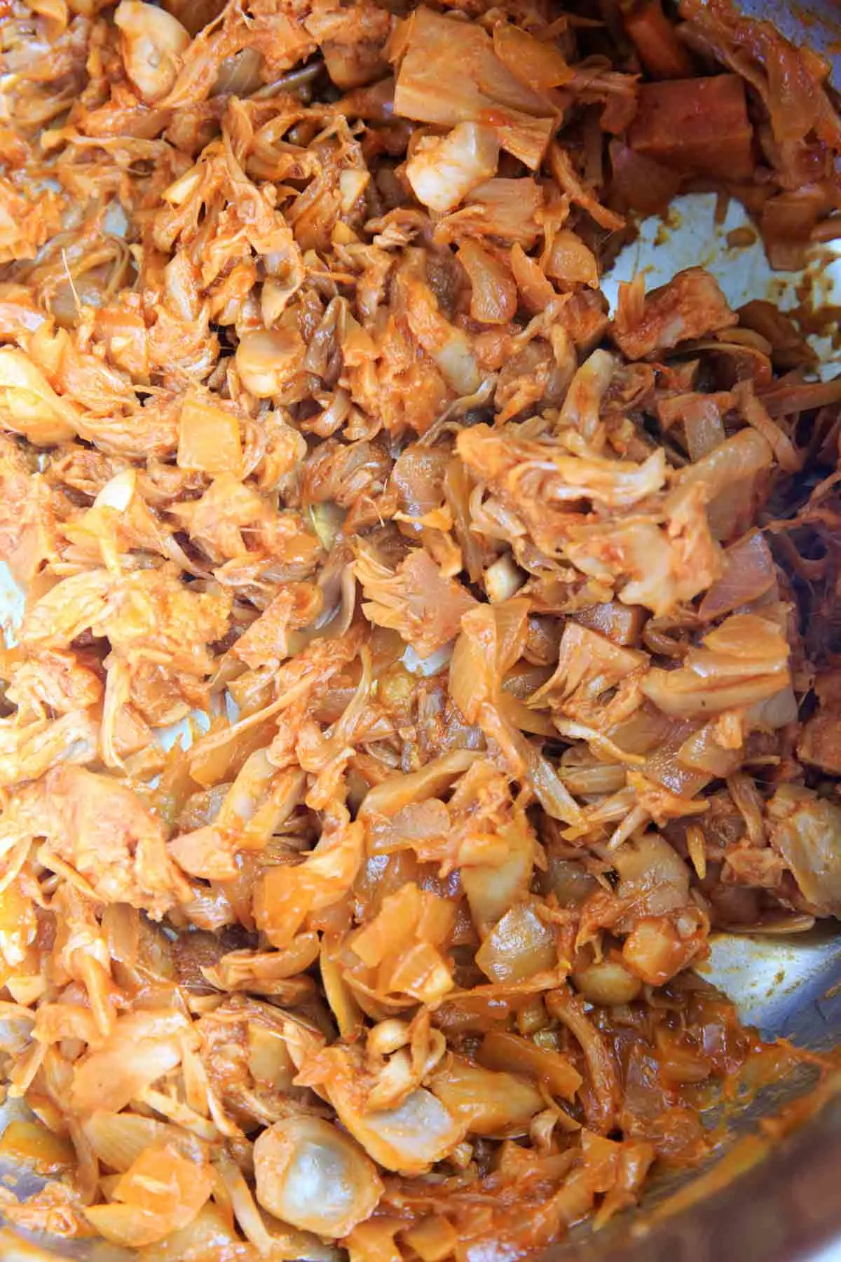 bbq jackfruit cooking in pot, after pulling apart