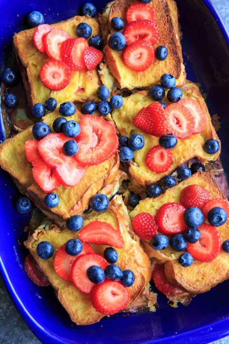 Summer Berry Stuffed French Toast Casserole Bake. Stuffed with cream cheese, fruit jam, strawberries and blueberries and topped with more berries! Serve with a sprinkle of powdered sugar and/or maple syrup if desired. Breakfast or brunch is served!