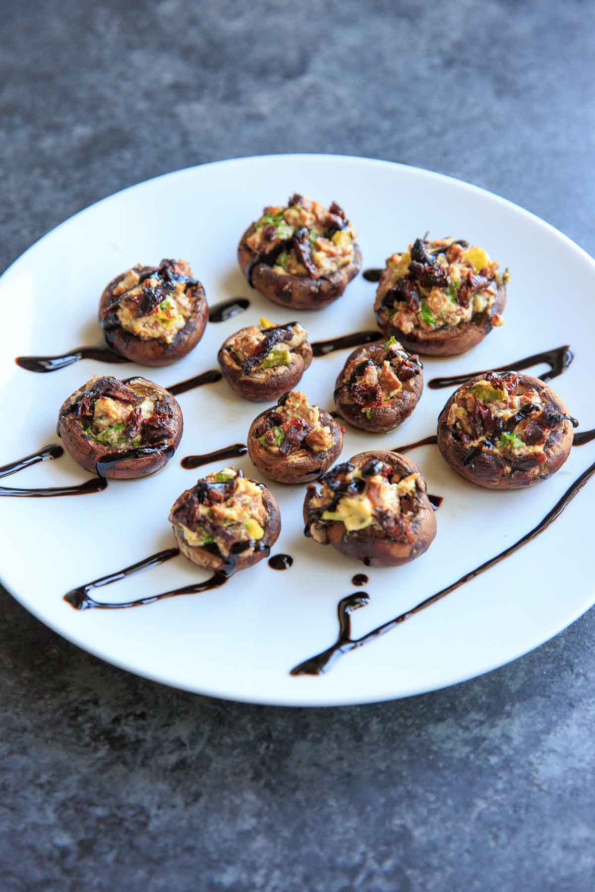 Chevre Stuffed Mushrooms with Sun-dried Tomatoes are an easy finger food or appetizer that is full of flavor! Option to mix it up with different flavors of goat cheese or sprinkle with herbs and balsamic vinegar.