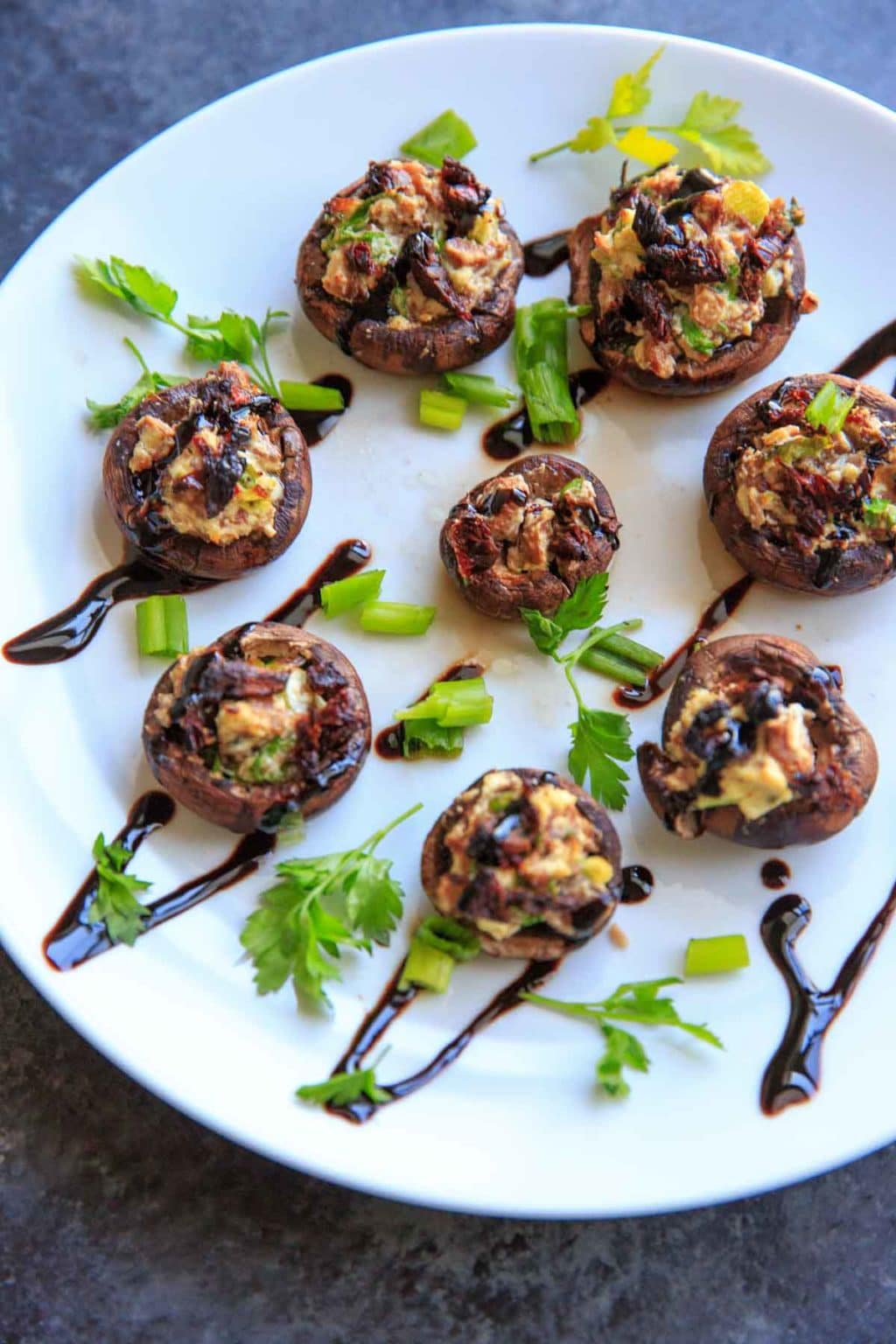 Chevre Stuffed Mushrooms with Sun-dried Tomatoes are an easy finger food or appetizer that is full of flavor! Option to mix it up with different flavors of goat cheese or sprinkle with herbs and balsamic vinegar.