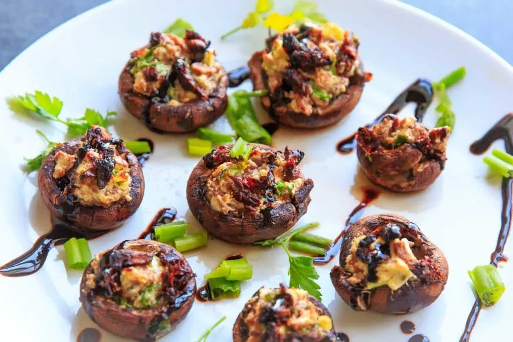 Chevre Stuffed Mushrooms with Sun-dried Tomatoes are an easy finger food or appetizer that is full of flavor! Option to mix it up with different flavors of goat cheese or sprinkle with herbs and balsamic vinegar.