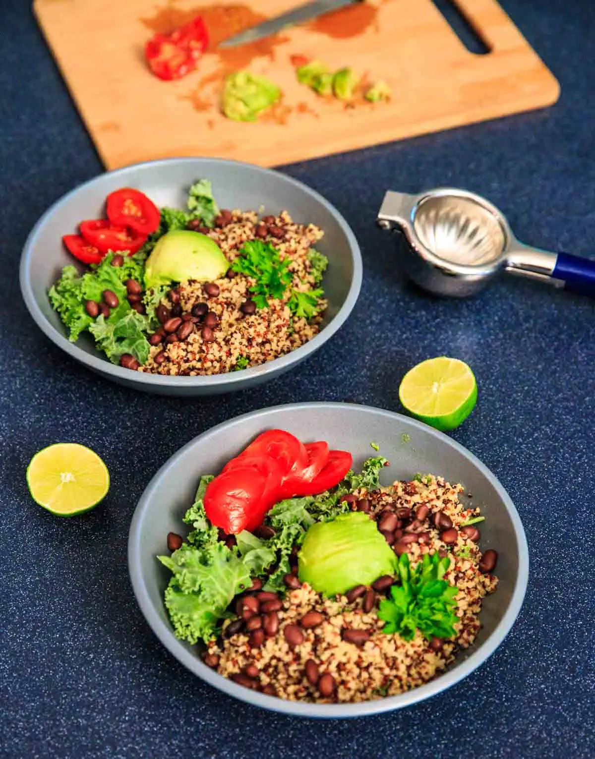 A customizable vegan and gluten-free buddha bowl with kale, quinoa, tomato, avocado, black beans, corn, and more!