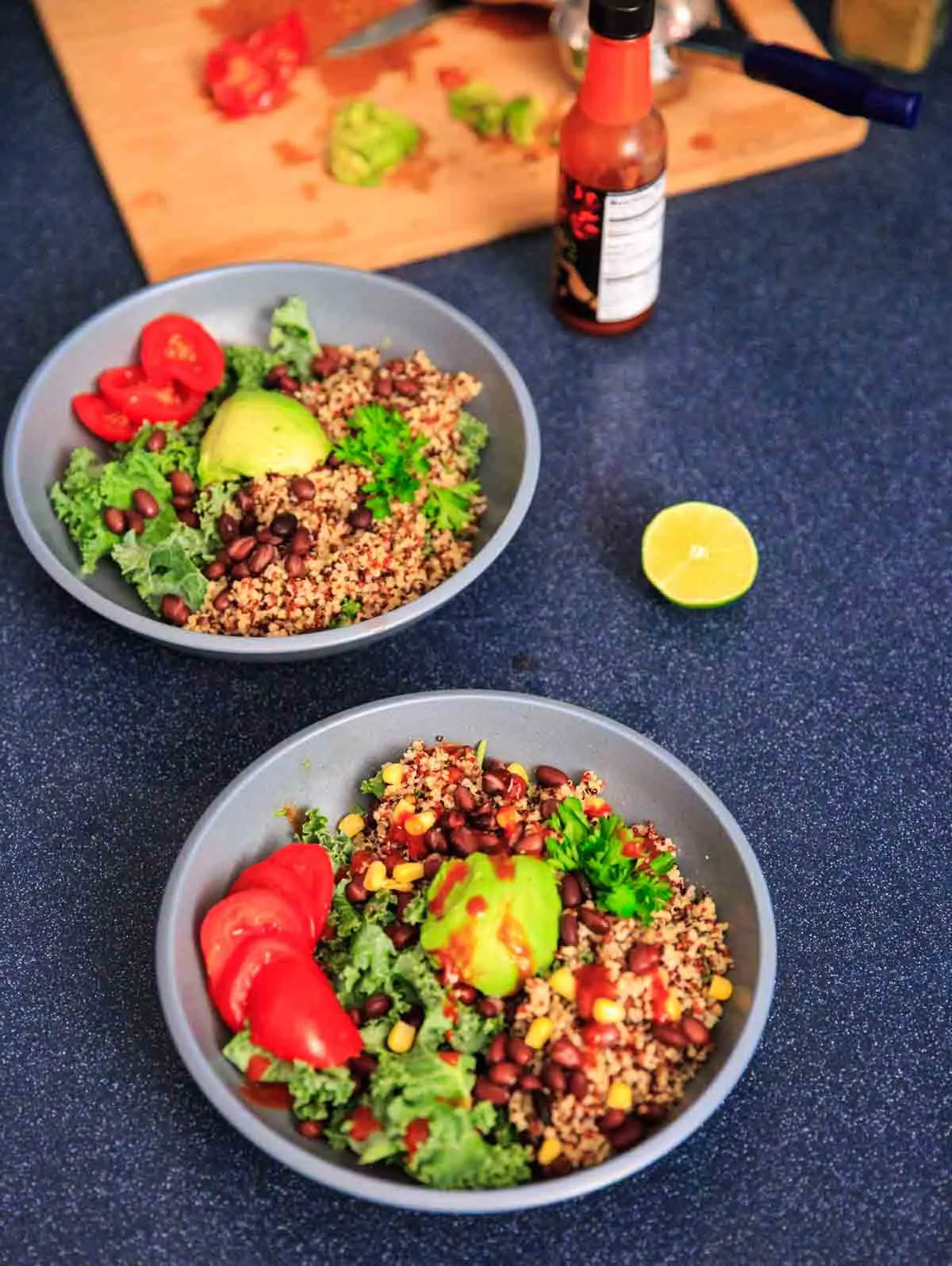 A customizable vegan and gluten-free buddha bowl with kale, quinoa, tomato, avocado, black beans, corn, and more!