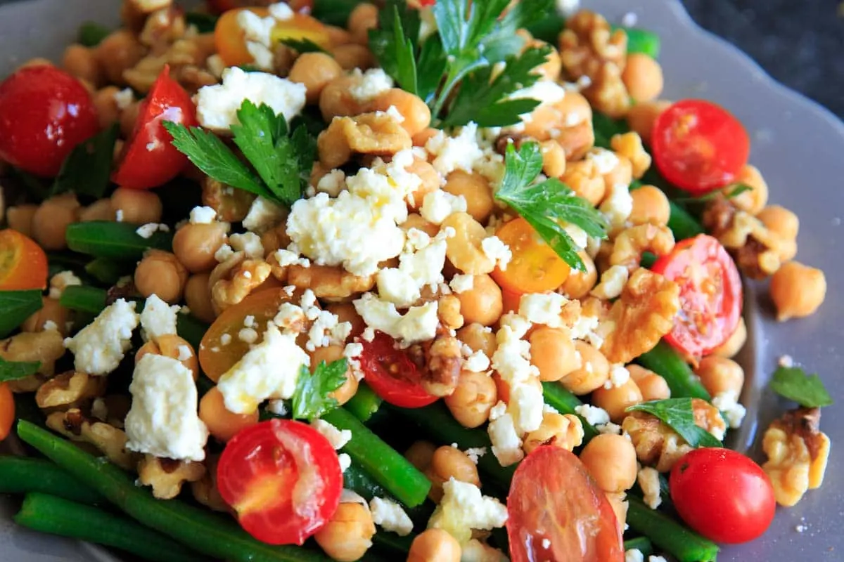 Green Bean Chickpea Salad with tomato, walnuts and feta. A great appetizer or side dish for dinners or holiday gatherings!