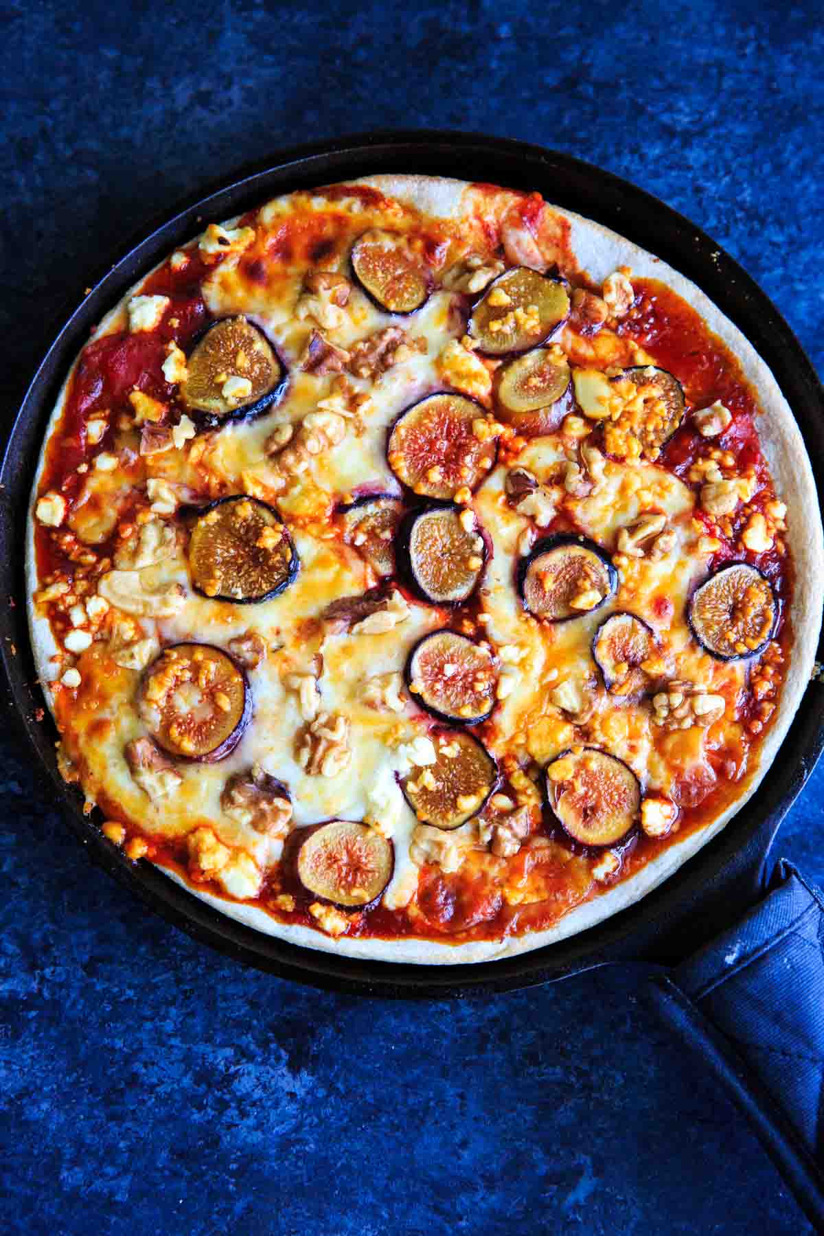 Honey Fig Pizza with Feta Cheese and Walnuts on cast iron pan