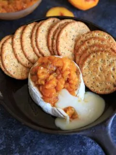 Peach Jalapeno Honey Baked Brie - a delicious party appetizer or game time food. Dip with crackers or veggies!