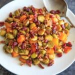 Maple Roasted Brussels Sprout and Butternut Squash with crushed pecans and dried cranberries. A perfect appetizer or side for holiday or fall dinners.