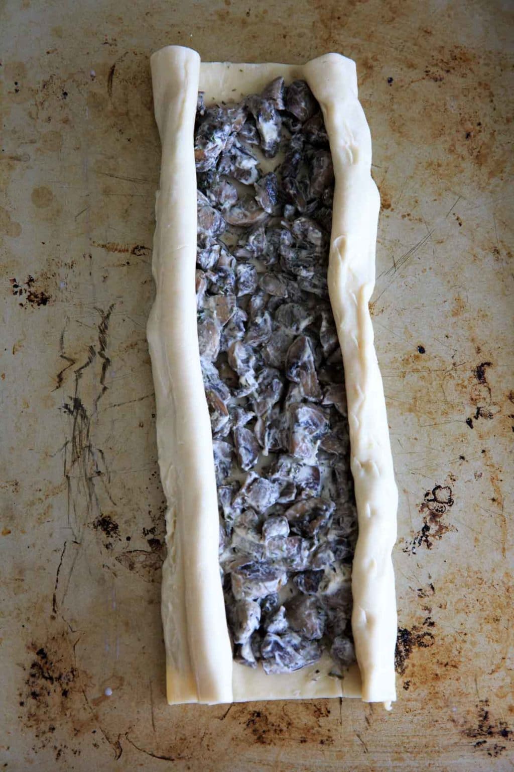 Making mushroom palmiers in puff pastry - rolling the puff pastry sides over into elephant ears