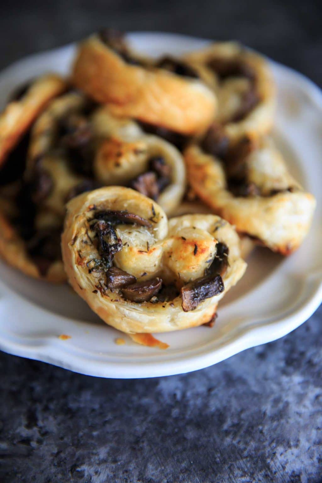 baked savory mushroom palmiers on white plate