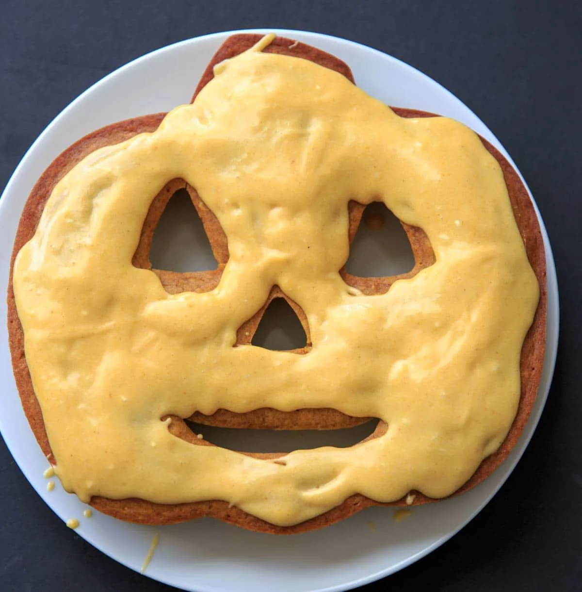 Pumpkin Cake with Pumpkin Cream Cheese Icing on white plate