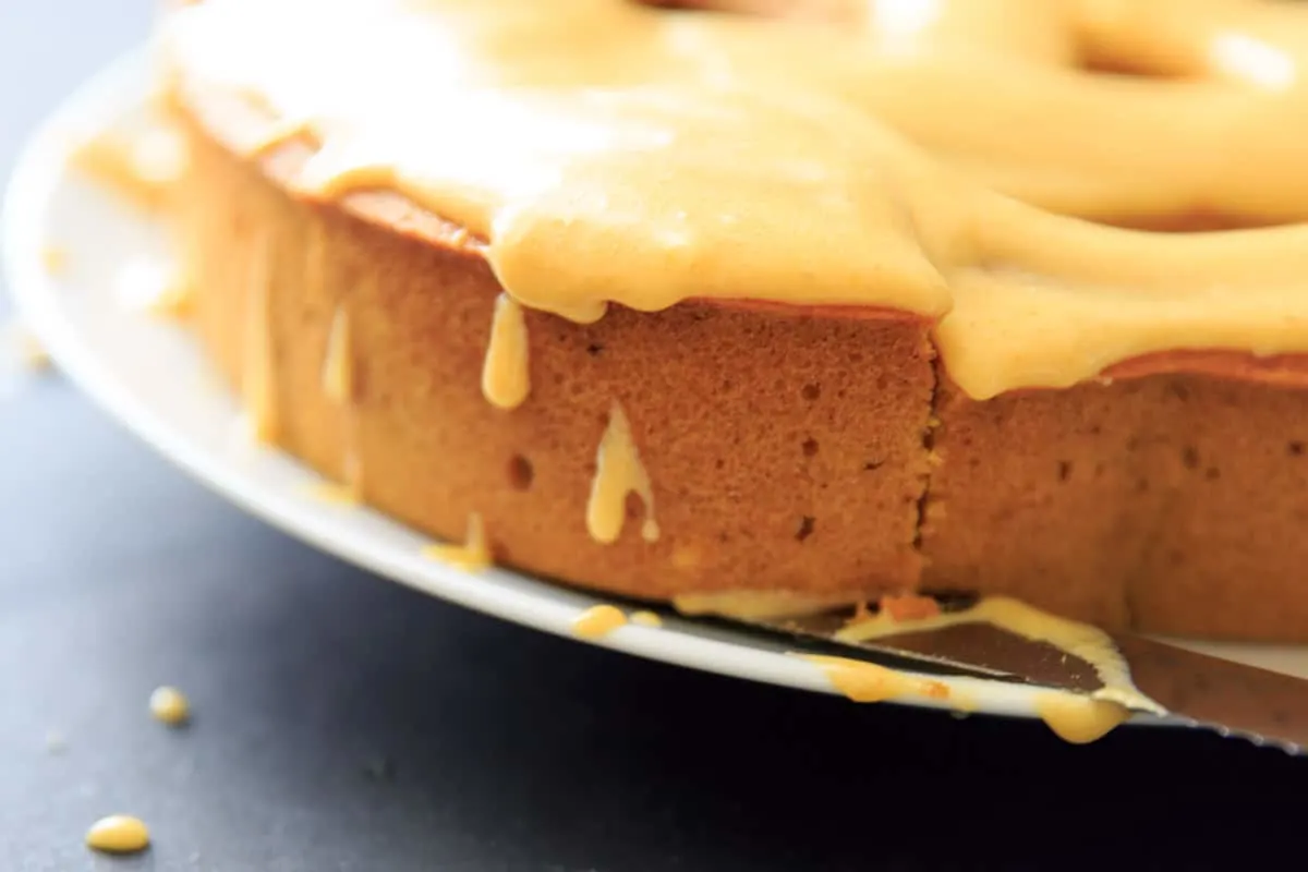 Pumpkin Cake with Pumpkin Cream Cheese Icing. Cutting a piece of the cake.